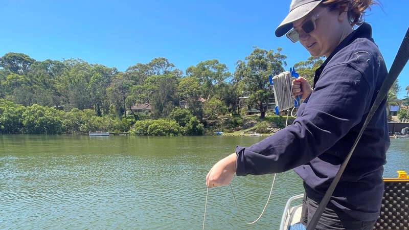 Lydia sampling water in the Georges River