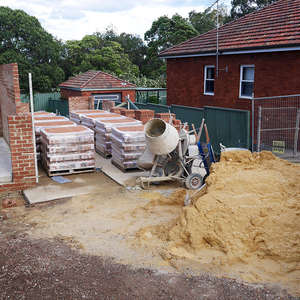 loose piles of sand on a building site that have not been secured with a cover