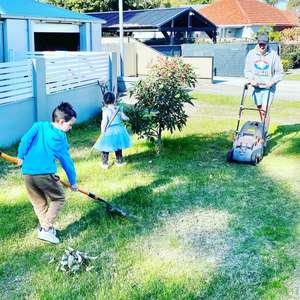 Love Your Waterways Instagram competition winning photo shows a young family mowing with a catcher and raking garden clippings so they don't enter the gutter