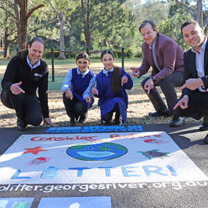VIPs from Georges Riverkeeper and City of Canterbury Bankstown with students from St Mary's Primary School Georges Hall with the finished artworks