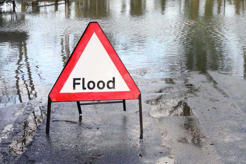 Flood sign warns people not to enter floodwaters