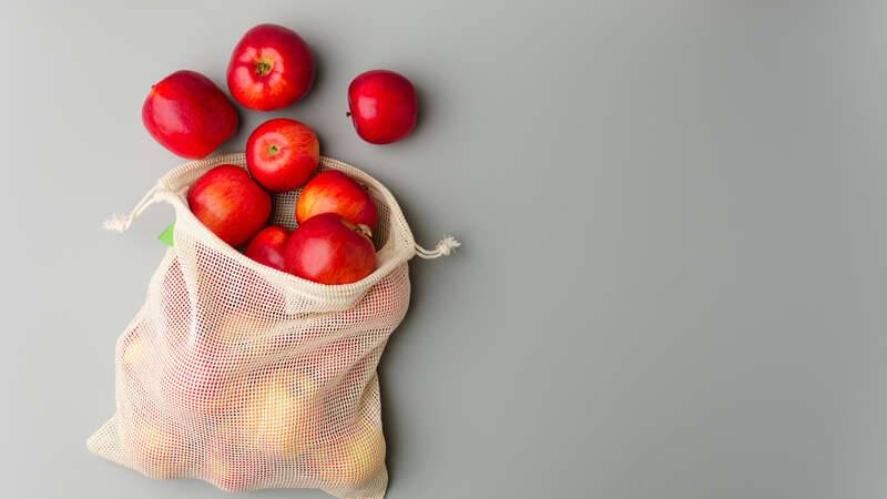 red apples in a reusable mesh bag