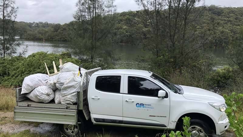 Georges Riverkeeper truck collecting rubbish bags filled with debris