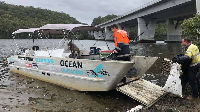 Ocean Crusaders barge picking up rubbish from Georges River as part of the hard core cleaning in 2020